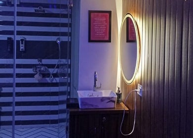 Luxurious bathroom with round mirror at Cora Spa, New Delhi, Delhi, IN.