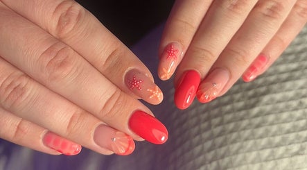 Vibrant starfish nail art by Nails by Maddy, Truro, England, GB showcases trendy summer designs.