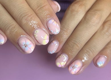 Floral nail art with a pink theme at Nails by Maddy, Truro, England, GB offering elegant beauty services.