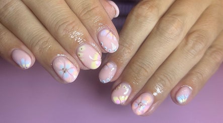 Floral nail art with a pink theme at Nails by Maddy, Truro, England, GB offering elegant beauty services.