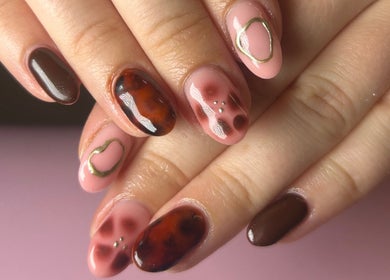 Elegant nail art design at Nails by Maddy in Truro, England, GB showcasing glossy, earthy tones.
