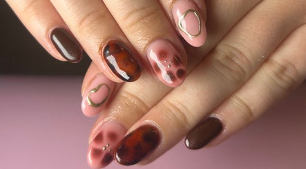 Elegant nail art design at Nails by Maddy in Truro, England, GB showcasing glossy, earthy tones.