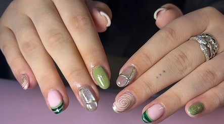 Chic nail art featuring green and pink designs at Nails by Maddy, Truro, England, GB for stylish looks.