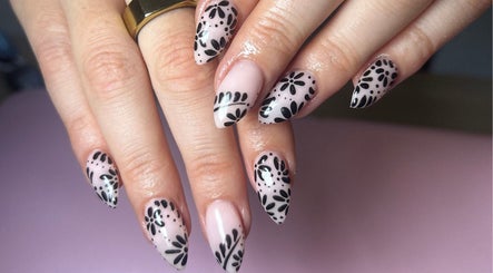 Stylish black floral nail art at Nails by Maddy, Truro, England, GB.