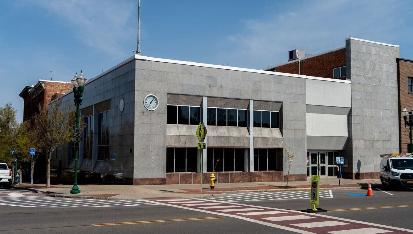 Exterior view of Foxie Waxing & Beauty in Auburn, New York, US; modern facade with clock.