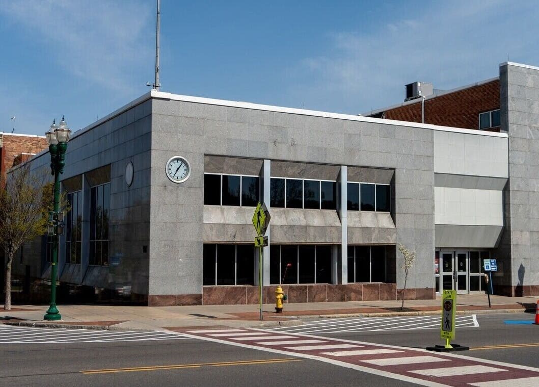 Exterior view of Foxie Waxing & Beauty in Auburn, New York, US; modern facade with clock.