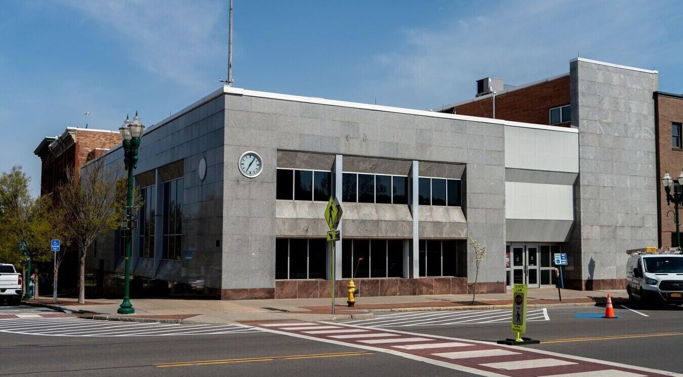 Exterior view of Foxie Waxing & Beauty in Auburn, New York, US; modern facade with clock.