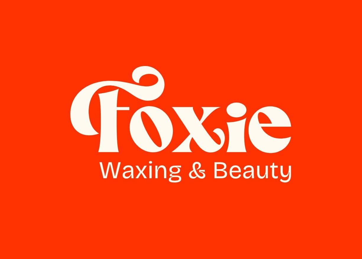Bold Foxie Waxing & Beauty logo on a vibrant orange background in Auburn, New York, US.
