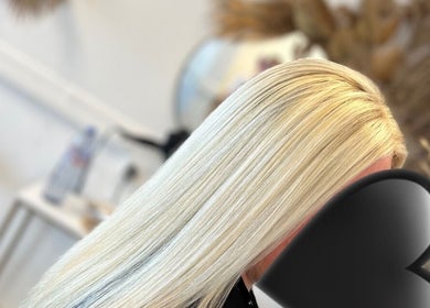 Sleek blonde hair styled at Opal & Mane, Sunderland, England, GB. A modern salon experience.
