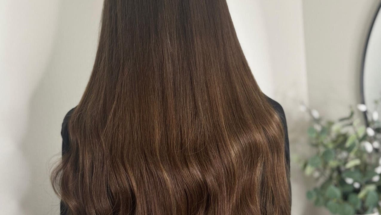 Silky, brown hair styled at Opal & Mane in Sunderland, England, GB, showcasing vibrant shine and healthy texture.