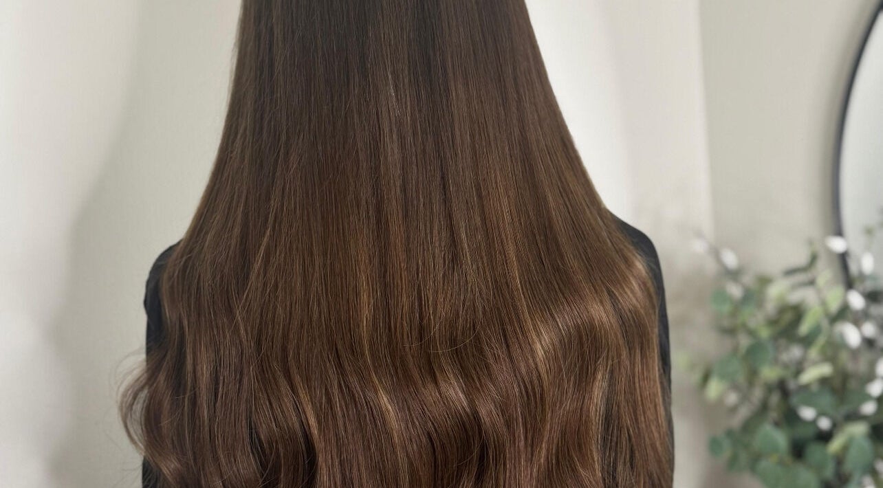 Silky, brown hair styled at Opal & Mane in Sunderland, England, GB, showcasing vibrant shine and healthy texture.