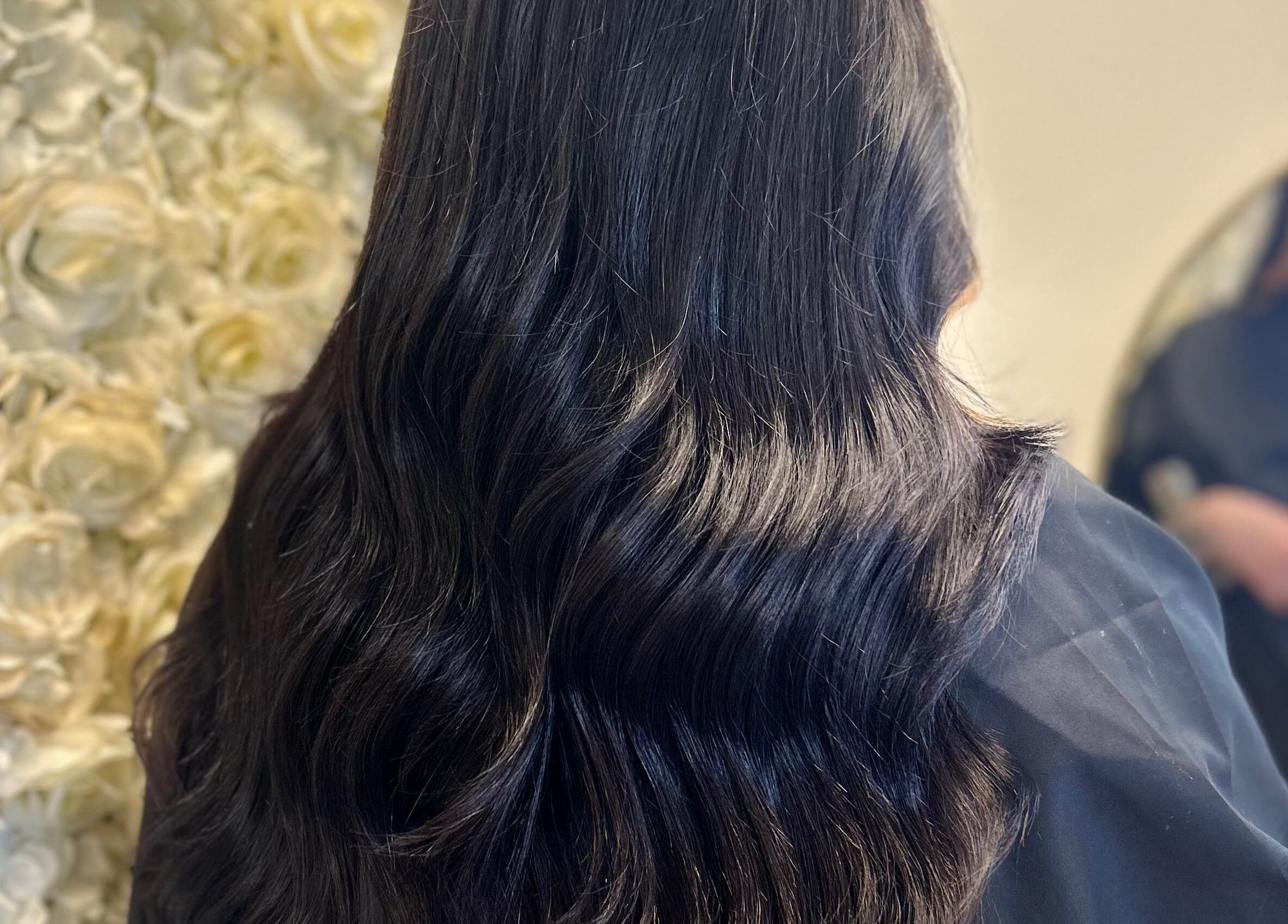 Glossy black hair styled in waves at Opal & Mane, Sunderland, England, GB.