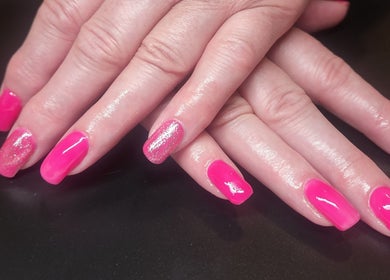 Vibrant pink nail art at Netty's Nail Studio, Pocatello, Idaho, US. Glitter accent adds sparkle.
