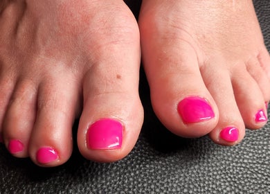 Bright pink pedicure at Netty's Nail Studio, Pocatello, Idaho, US, showcasing vibrant nail art.
