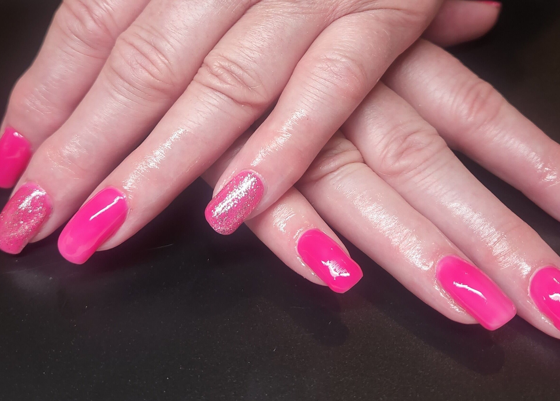 Bright pink nail art with glitter at Netty's Nail Studio, Pocatello, Idaho, US enhancing style.