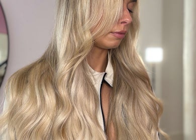Elegant blonde hair styled at lengthsbygi, located in Kirkintilloch, Scotland, GB, showcasing vibrant waves.