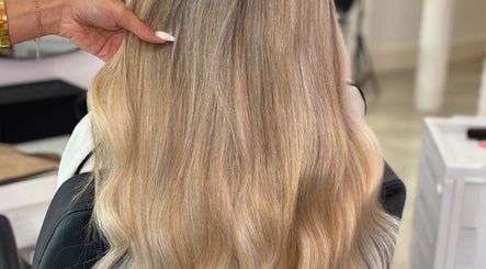 Long, shiny blonde hair styled at lengthsbygi, Kirkintilloch, Scotland, GB, showcasing smooth finish.