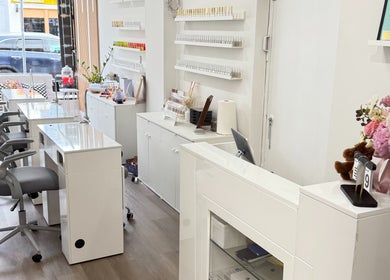 Modern interior of Glossé Nails in Vancouver, British Columbia, CA, featuring chic nail stations and elegant decor.