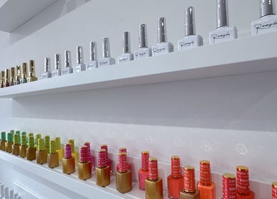 Glossé Nails, Vancouver, BC: Shelves of colorful nail polishes creating an inviting ambiance at the salon.