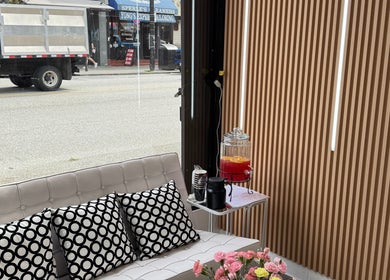 Stylish lounge area at Glossé Nails, Vancouver, British Columbia, CA with modern decor and refreshments.