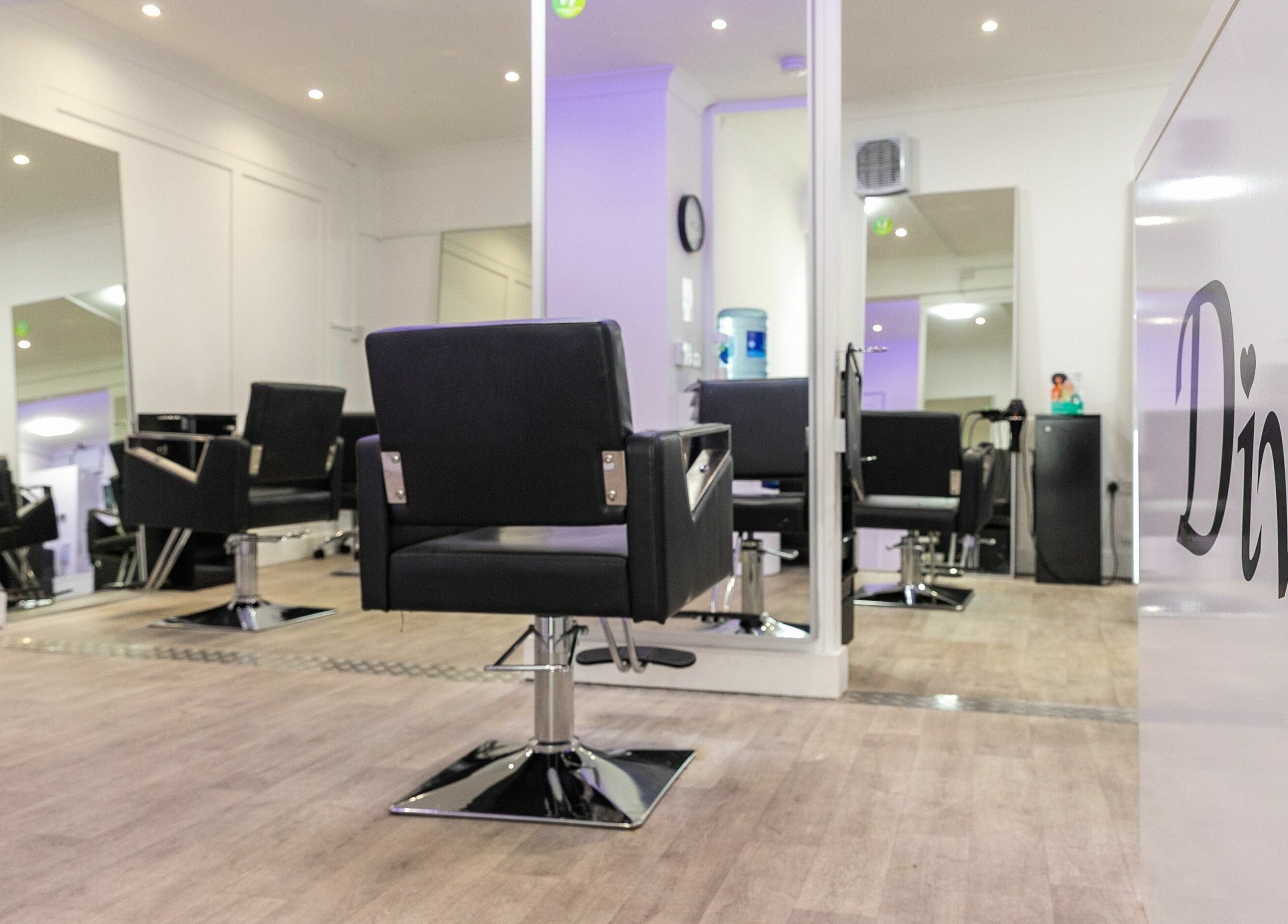 Interior of Divas Hair salon in Cheshunt, England, GB showcasing modern styling chairs and sleek decor.