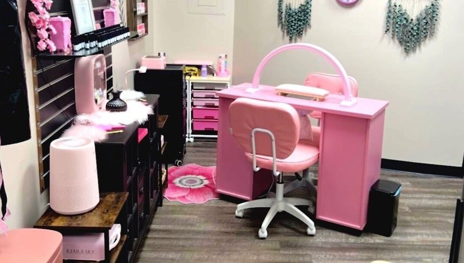 Cozy pink nail station at Mystique Nails in Alpena, Michigan, US with cute decor and modern amenities.