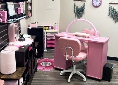 Chic nail station at Mystique Nails, Alpena, Michigan, US featuring plush pink seating and elegant decor.