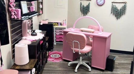 Chic nail station at Mystique Nails, Alpena, Michigan, US featuring plush pink seating and elegant decor.