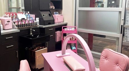 Stylish pink nail station at Mystique Nails in Alpena, Michigan, US, showing manicure setup and supplies.