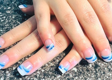 Elegant blue and white nail art manicure at Mystique Nails, Alpena, Michigan, US.