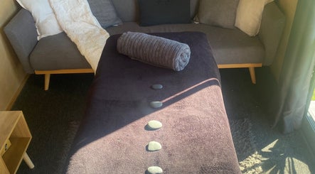 Relaxing massage bed with stones at Mirimiri Mai Rā, Rotorua, Bay Of Plenty Region, NZ.