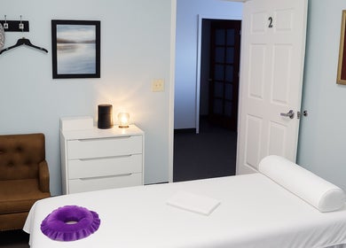 Releaf Massage & Health Spa 宁静按摩室，位于 Mesa, Arizona, US，带有舒适的椅子和装饰墙画。