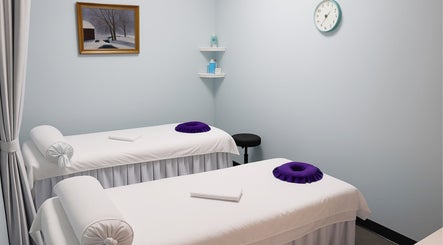 Tranquil massage room at Releaf Massage & Health Spa, Mesa, Arizona, US, featuring two white massage tables.