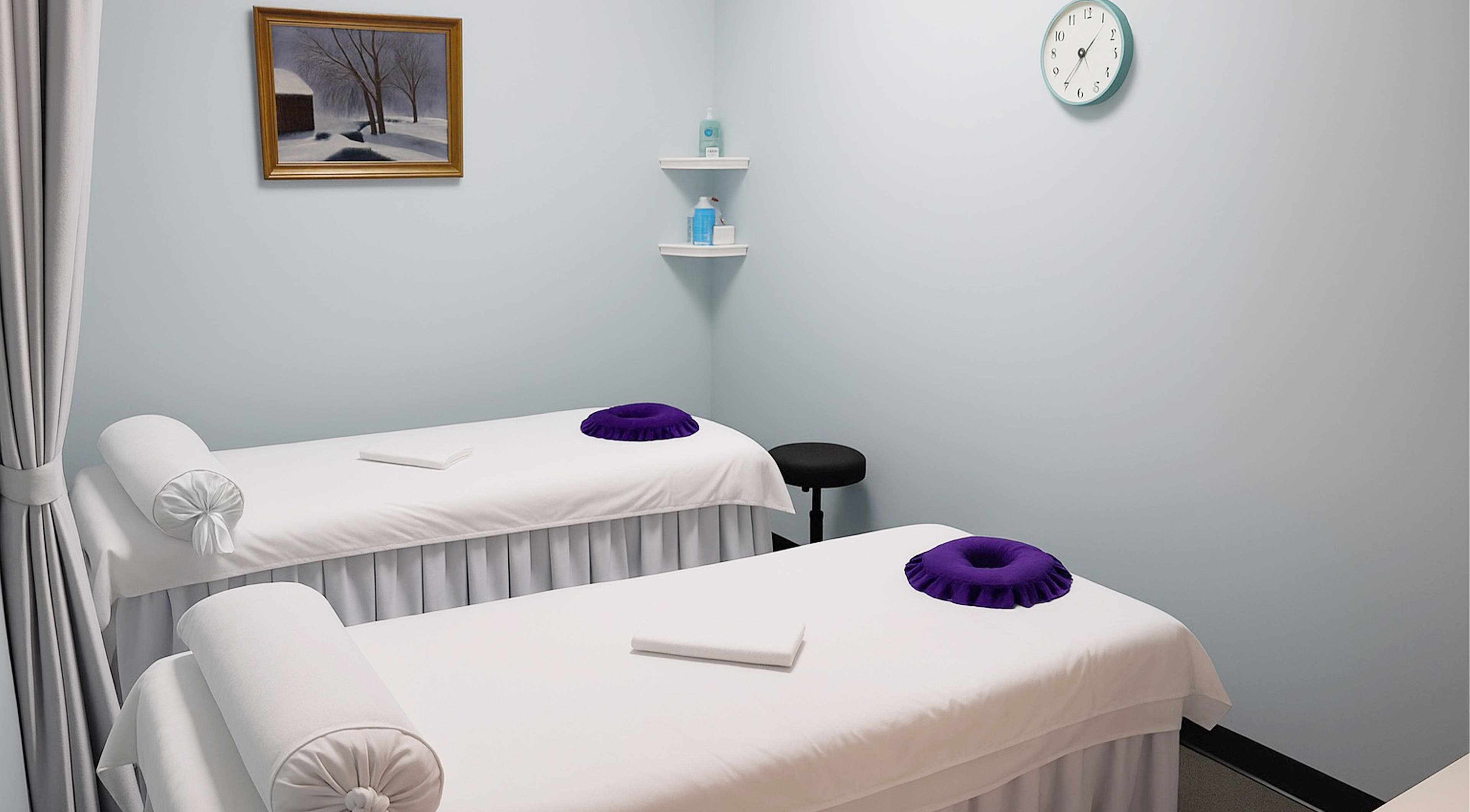 Tranquil massage room at Releaf Massage & Health Spa, Mesa, Arizona, US with dual treatment tables.