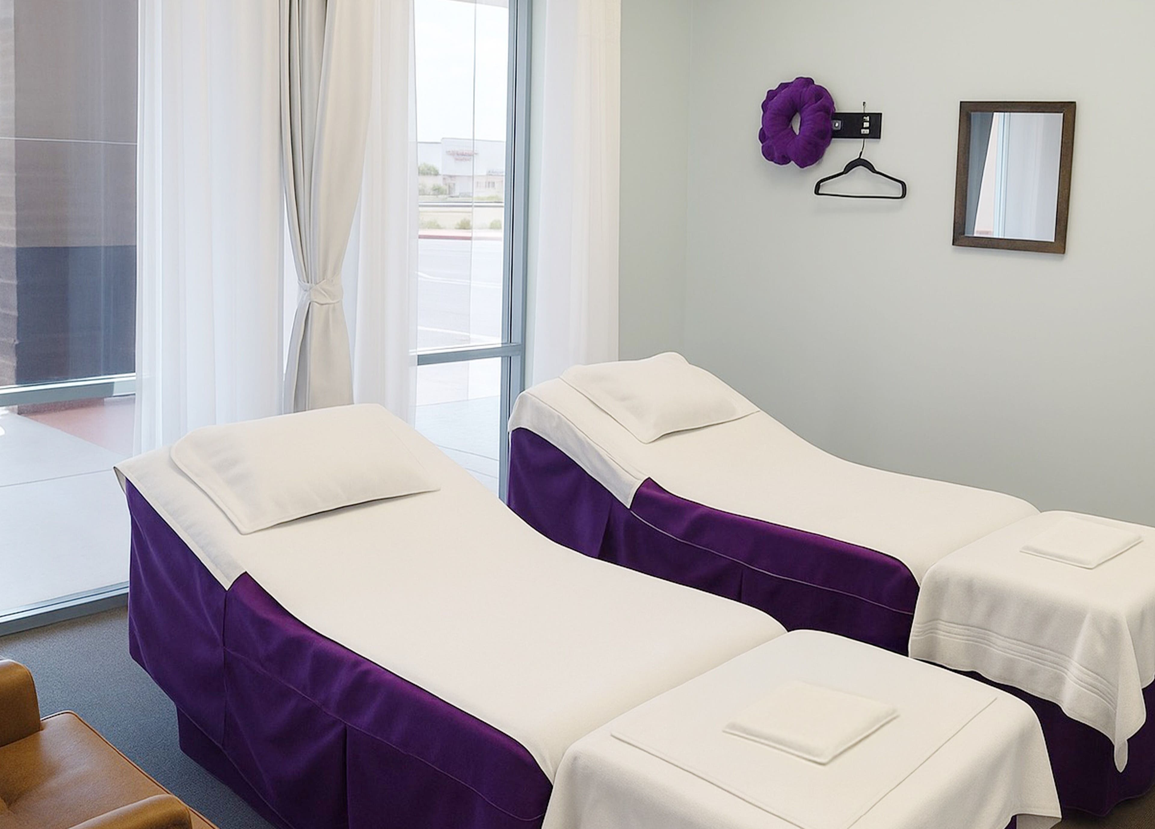 Relaxing massage room at Releaf Massage & Health Spa in Mesa, Arizona, US, with twin massage beds and soft lighting.