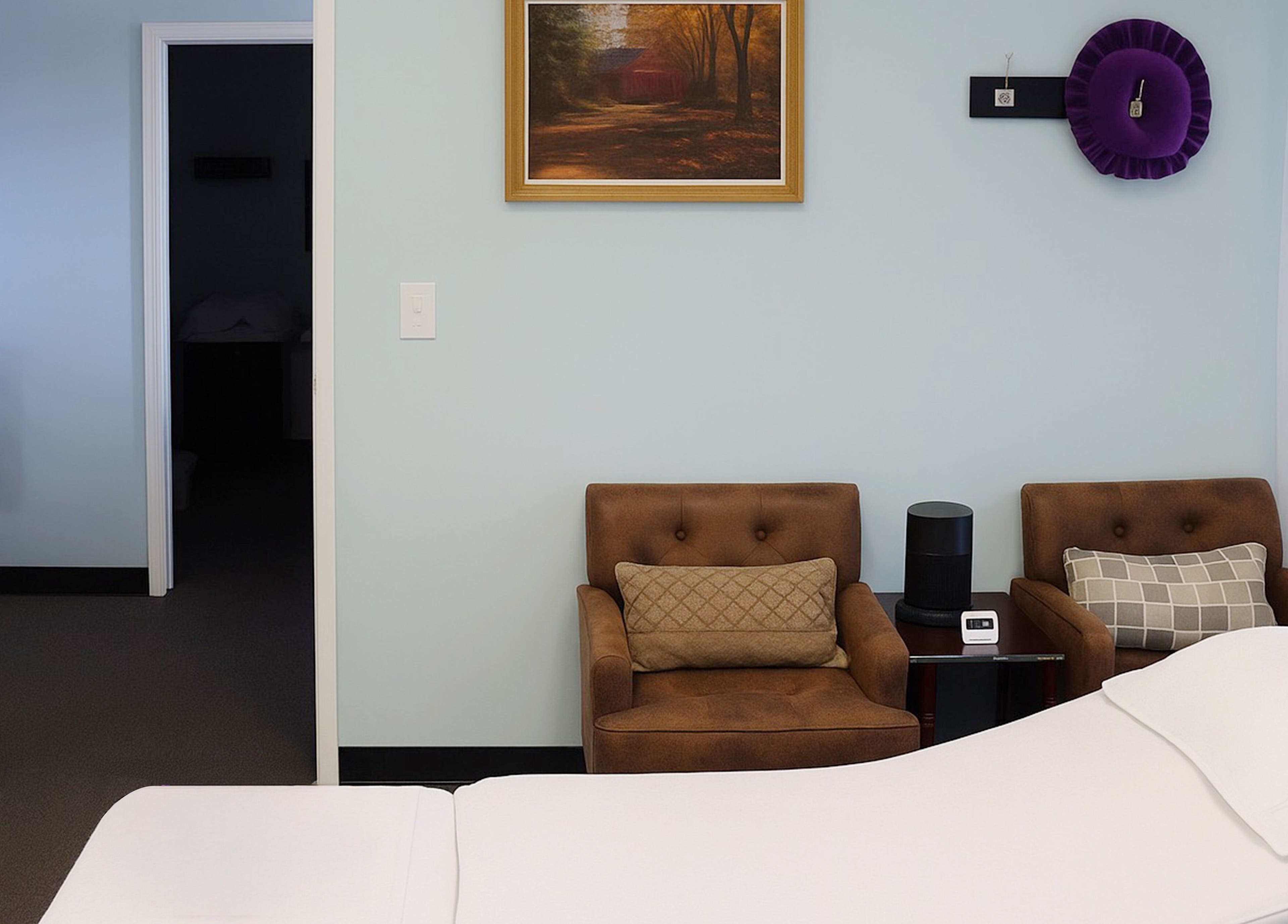 Calming massage room at Releaf Massage & Health Spa, Mesa, Arizona, US, with cozy chairs and a massage bed.