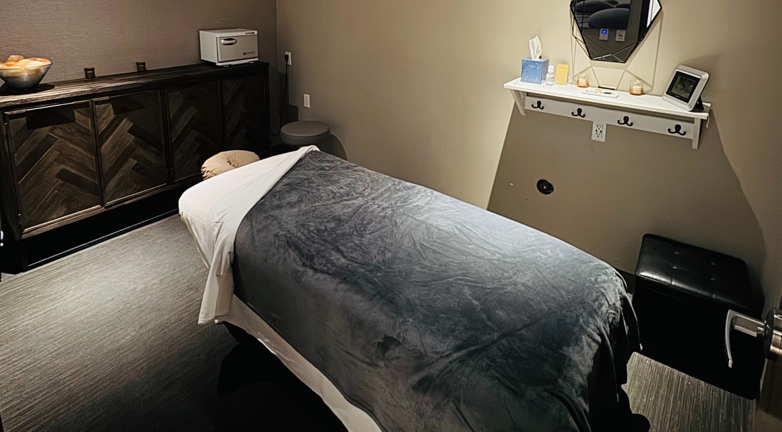 Tranquil massage room at Relax Ave Day Spa, Alamo, California, US with plush bedding and soothing decor.