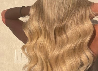 Blonde wavy hairstyle at HairbyStefaniia in Vaughan, Ontario, CA, showcasing radiant shine and expert styling.