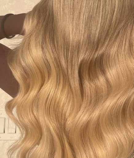 Blonde wavy hairstyle at HairbyStefaniia in Vaughan, Ontario, CA, showcasing radiant shine and expert styling.