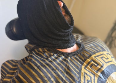 Client with a towel wrap at The Vigilante Barber, Erakala, Queensland, AU. Experience premium grooming services.