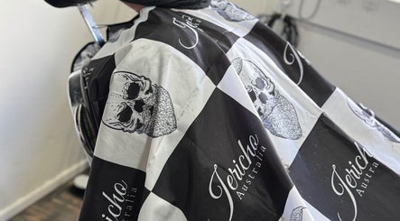 Edgy barber chair with skull-patterned cape at The Vigilante Barber in Erakala, Queensland, AU.