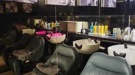 Modern salon area at LeeChul HairKerker Myeongdong 2nd Branch, Seoul, KR with sleek chairs and washing stations.