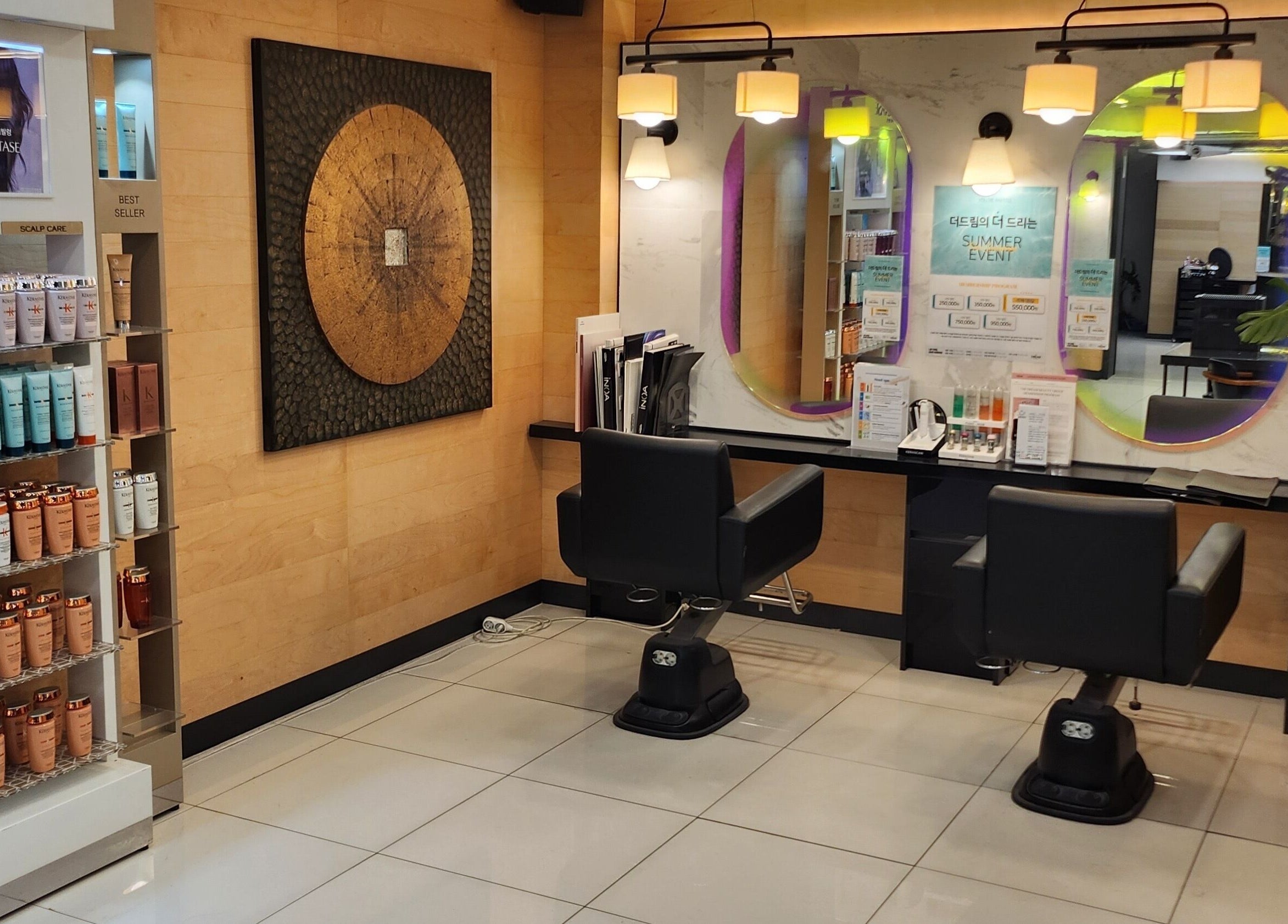 Stylish salon interior at 이철헤어커커 명동2호점 LeeChul HairKerker Myeongdong 2nd Branch in Seoul, KR showcasing beauty products.