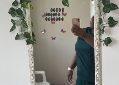 Mirror with vines and butterflies at Nika’s Styles & Smiles, Castries, LC, reflecting a serene setting.