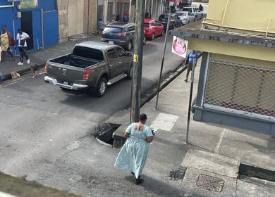 Street view near Nika’s Styles & Smiles, Castries, showcasing local urban life and vibrant surroundings.