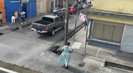 Street view near Nika’s Styles & Smiles, Castries, showcasing local urban life and vibrant surroundings.