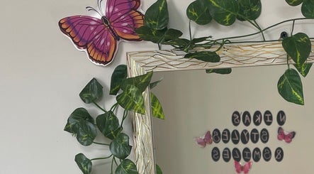 Decorative butterfly and greenery near mirror at Nika’s Styles & Smiles, Castries, Castries, LC.