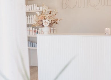 Reception area of Goddess Hair Co in Melbourne, Victoria, AU with sleek interiors and floral decor.