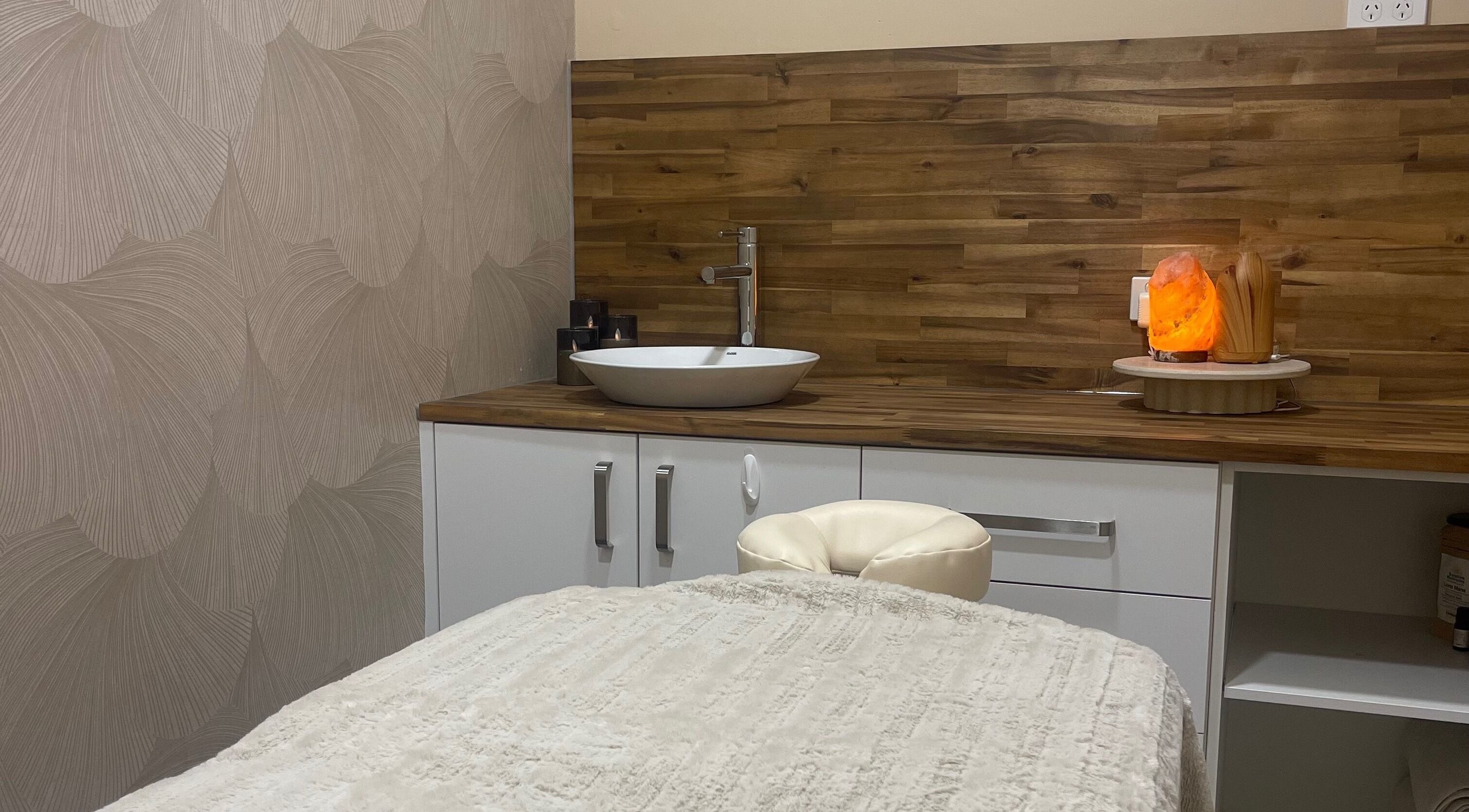 Tranquil massage room at Agata Skin and Beauty in Sippy Downs, Queensland, AU with wooden features and soft lighting.