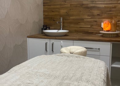 Cozy treatment room at Agata Skin and Beauty, Sippy Downs, Queensland, AU with plush bed and warm decor.